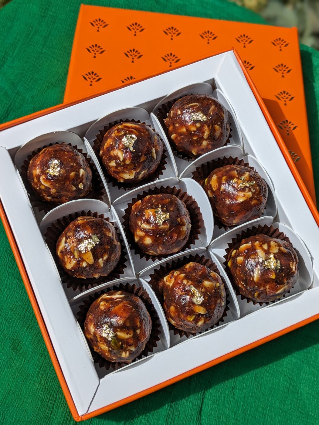 Date and nut ladoos with gold leaf